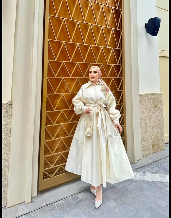 Timeless Elegance: Ivory Dress with Voluminous Skirt and Flower Brooch